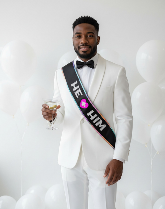 Littlegenie.com black satin sash with "HE + HIM" text and pink heart, perfect for bachelor parties.