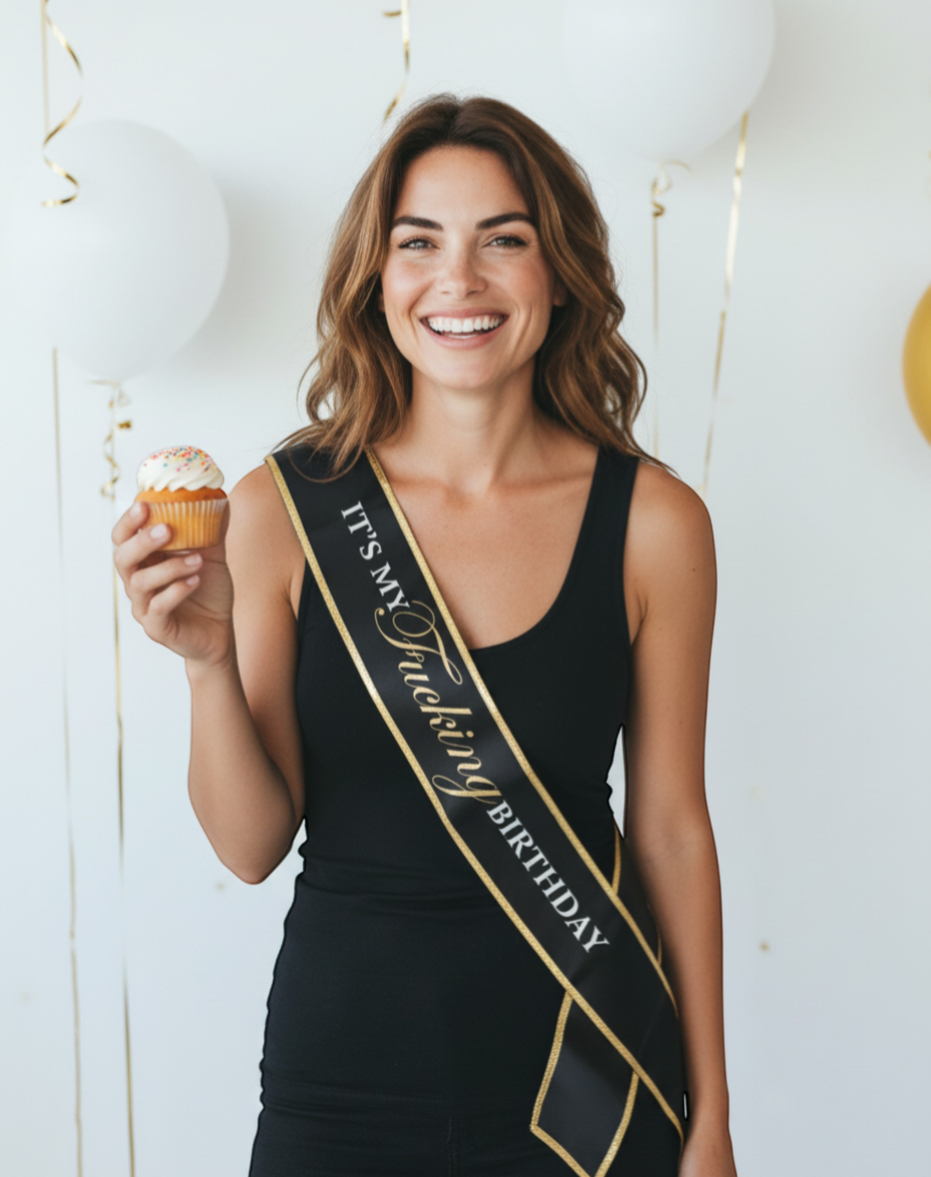 Littlegenie.com black satin birthday sash with gold foil text reading "IT'S MY FUCKING BIRTHDAY" and gold trim.